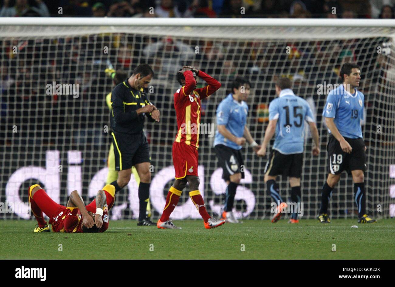 Soccer - 2010 FIFA World Cup South Africa - Quarter Final - Uruguay v Ghana - Soccer City Stadium. Ghana's Kevin-Prince Boateng (floor) and Anthony Annan react after Asamoah Gyan misses a penalty in the last minute of extra time Stock Photo