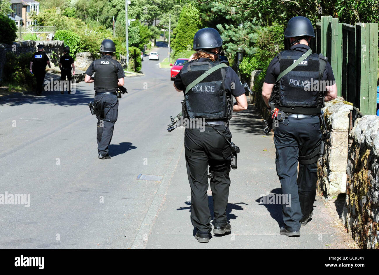 Armed police patrol a residential area of Rothbury, Northumberland, as