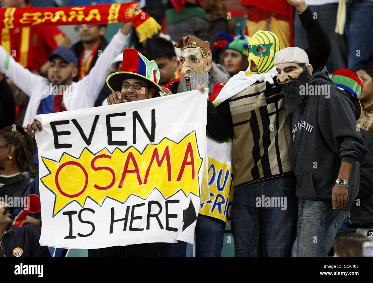 Soccer - 2010 FIFA World Cup South Africa - Semi Final - Germany v Spain - Durban Stadium. Fans wearing masks hold up a banner in the stands Stock Photo