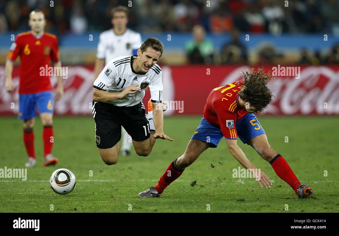 Soccer - 2010 FIFA World Cup South Africa - Semi Final - Germany v Spain - Durban Stadium. Germany's Miroslav Klose (left) and Spain's Carles Puyol (right) battle for the ball Stock Photo