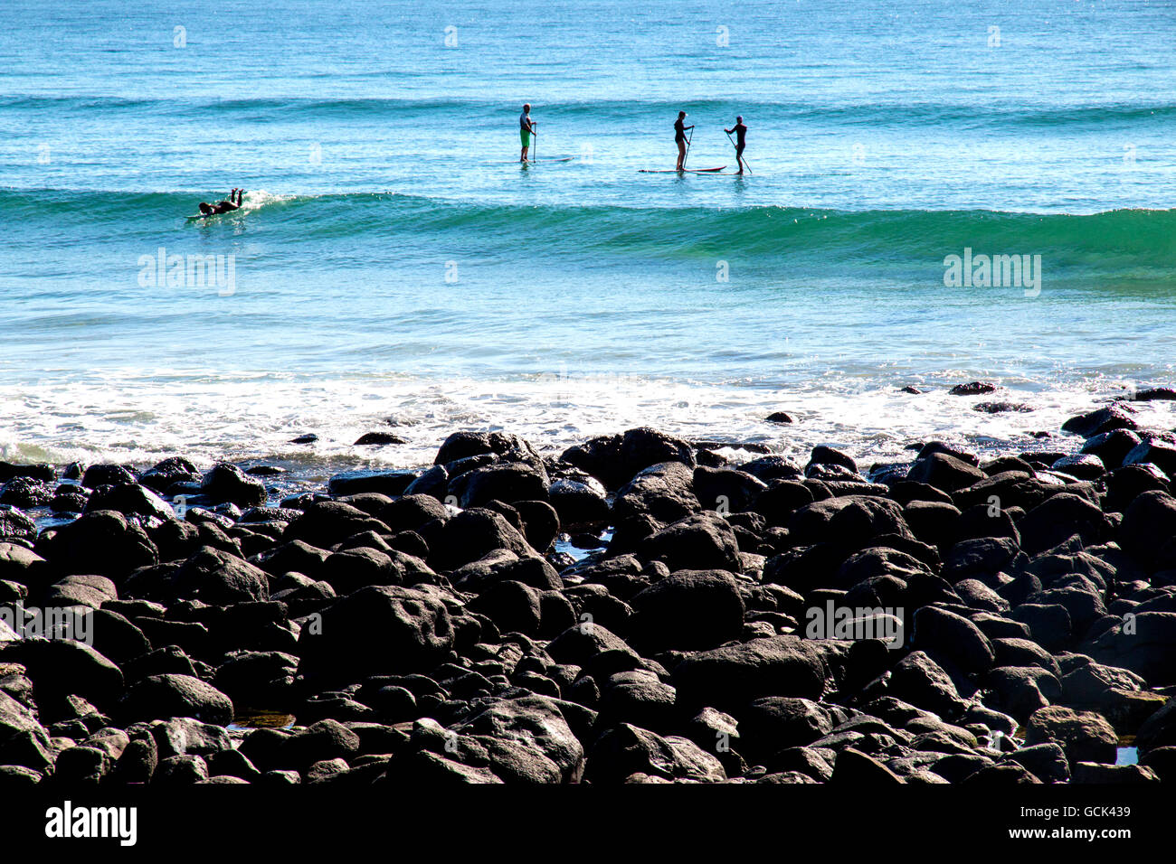 Board riders of various kinds off Burleigh Heads in Australia Stock Photo