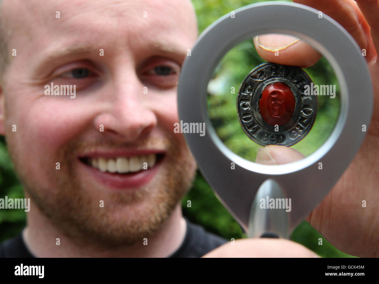 Photo dated 05/07/10 of metal-detecting enthusiast David Booth with a medieval seal matrix that he discovered in a field in Stirlingshire, it is decorated with a small stone carving or 'intaglio' and dates back 800 years to Roman times. Stock Photo