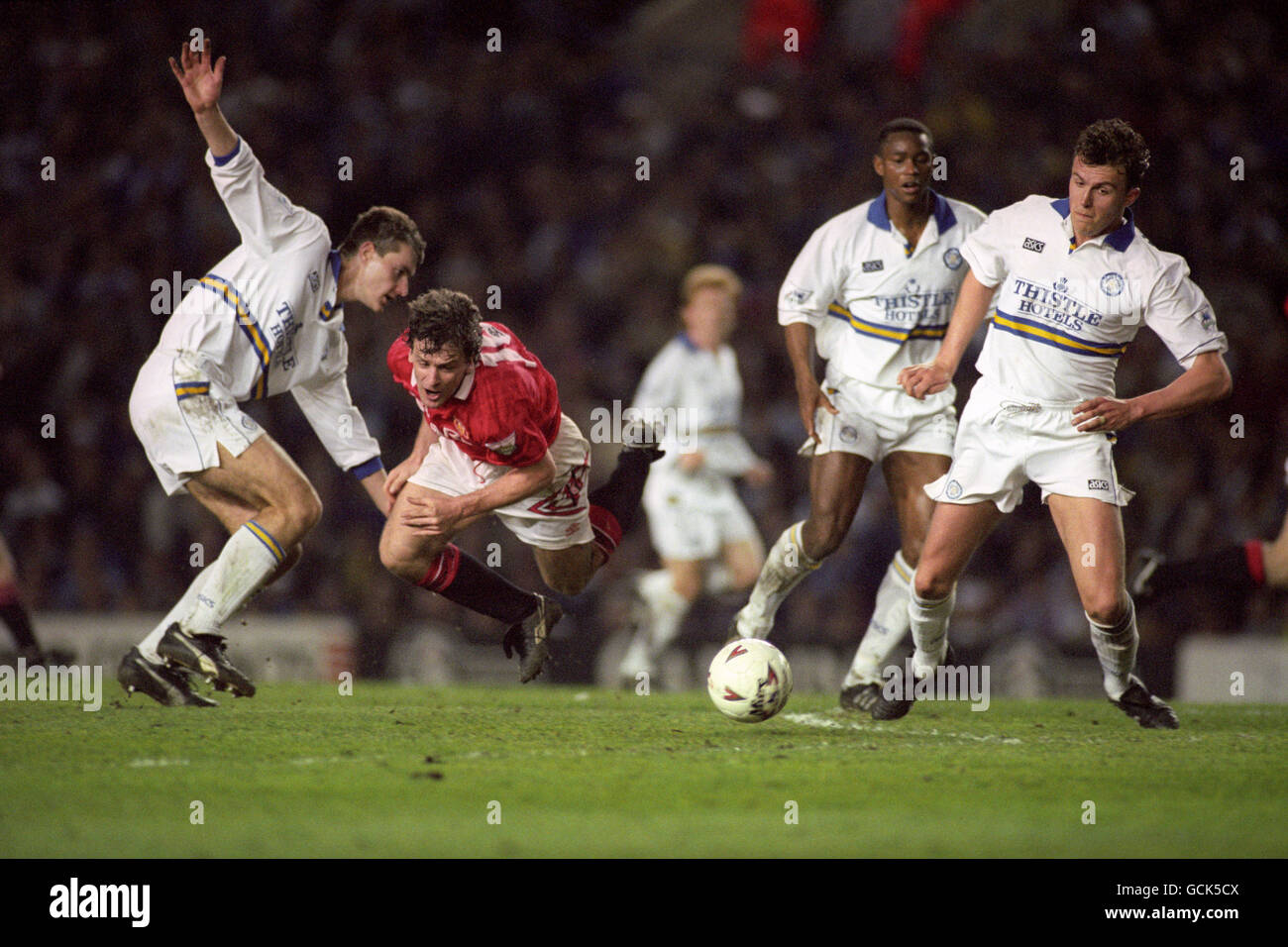 Leeds United defenders David Wetherall (l) and Jon Newsome (far right) help stop Manchester United's Mark Hughes attacking run. Stock Photo