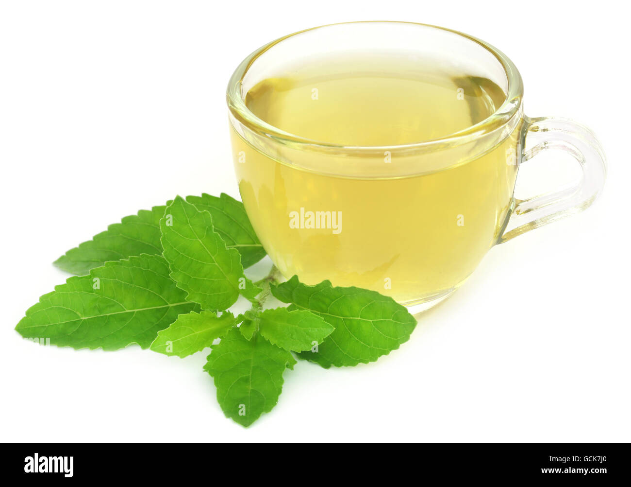 Herbal tea in a cup with tulsi leaves over white background Stock Photo Alamy