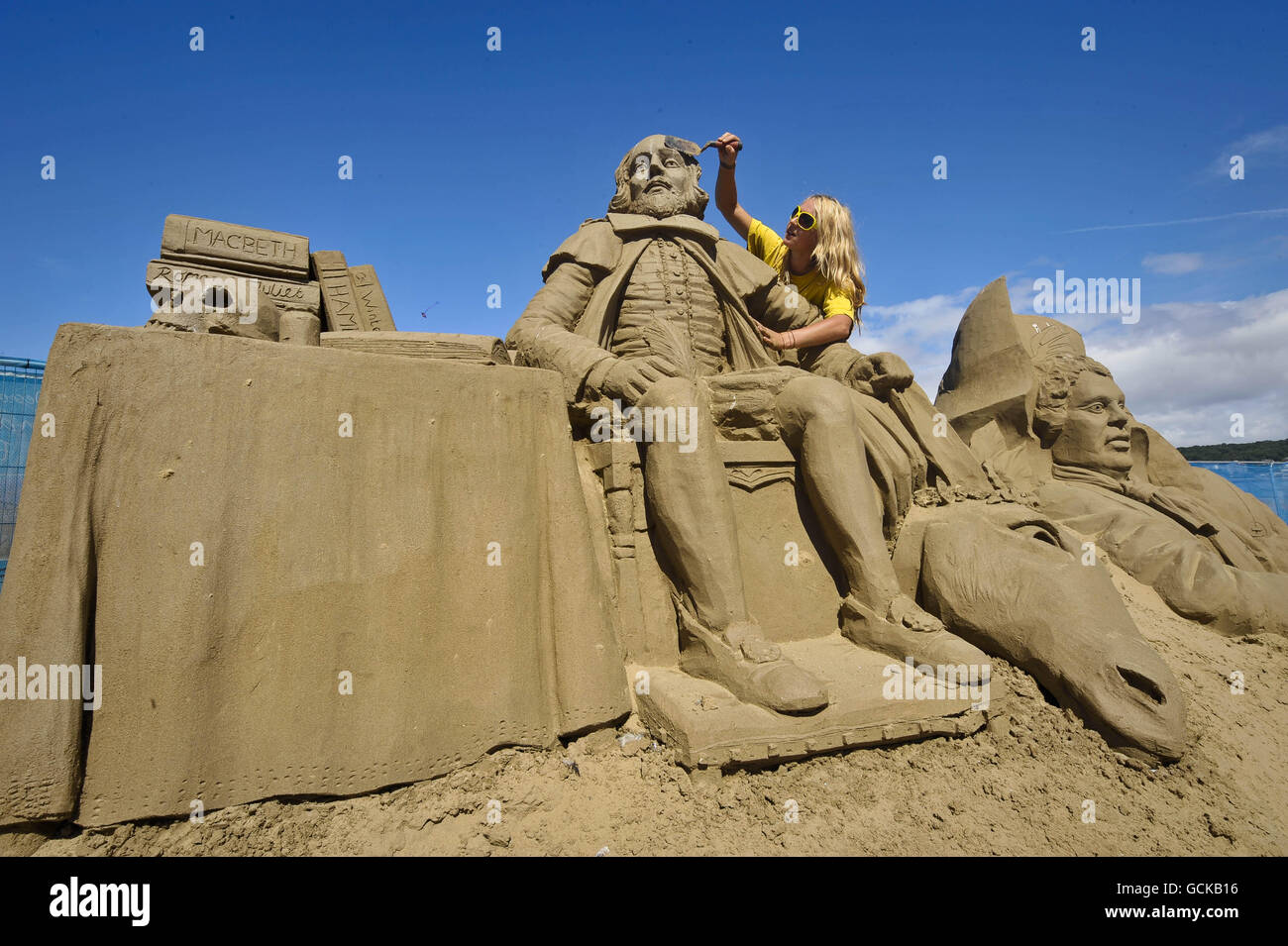 Sand sculptor and artist Nicola Wood, aged 27, from Leicester works on her sculpture of William Shakespear in the Weston-super-Mare Sand Sculpture Festival on the beach, which this year has the theme and celebration of all things British. Stock Photo