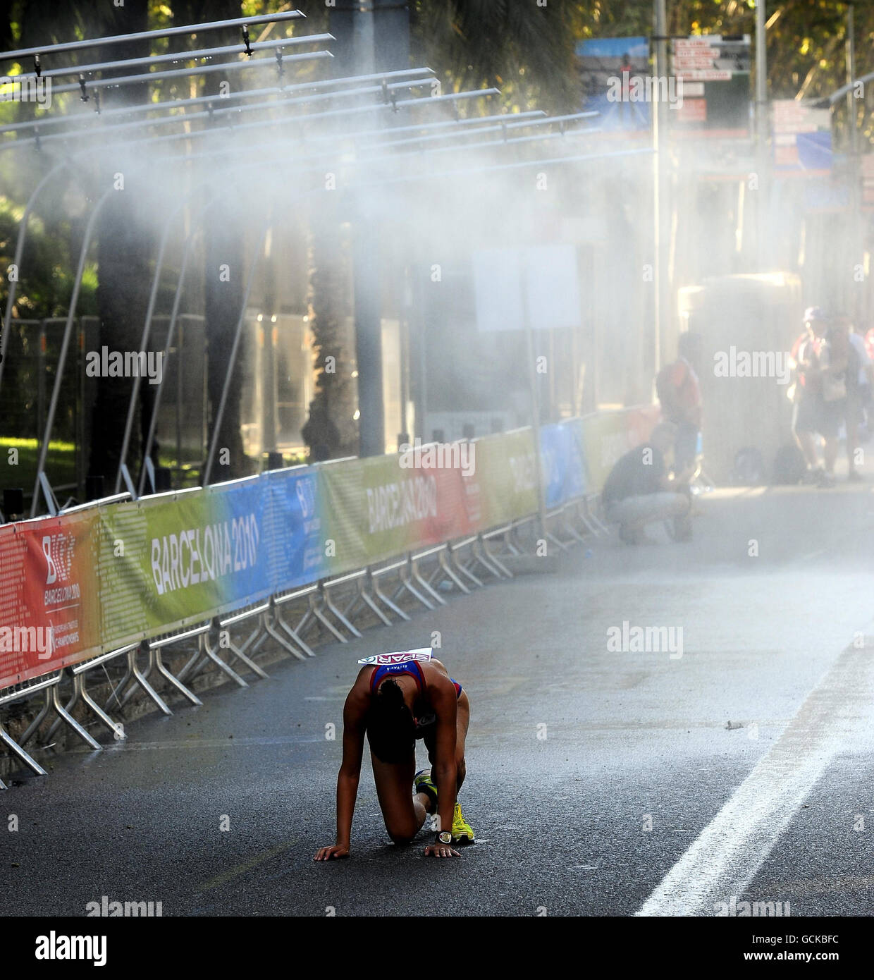 An exhausted Zuzana Malikova of Slovakia collapses as mist sprays out ...