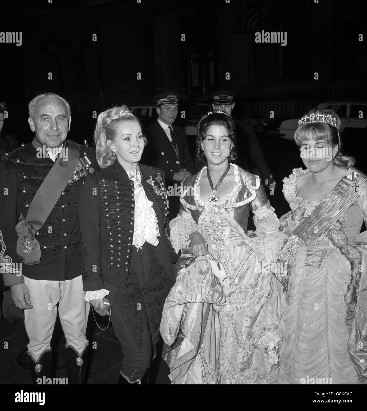 Actress Zsa Zsa Gabor, dressed in the uniform of a Hussar, with her husband, American industrialist Herbert Hutner, and her daughter Francesca Hilton, right. Stock Photo