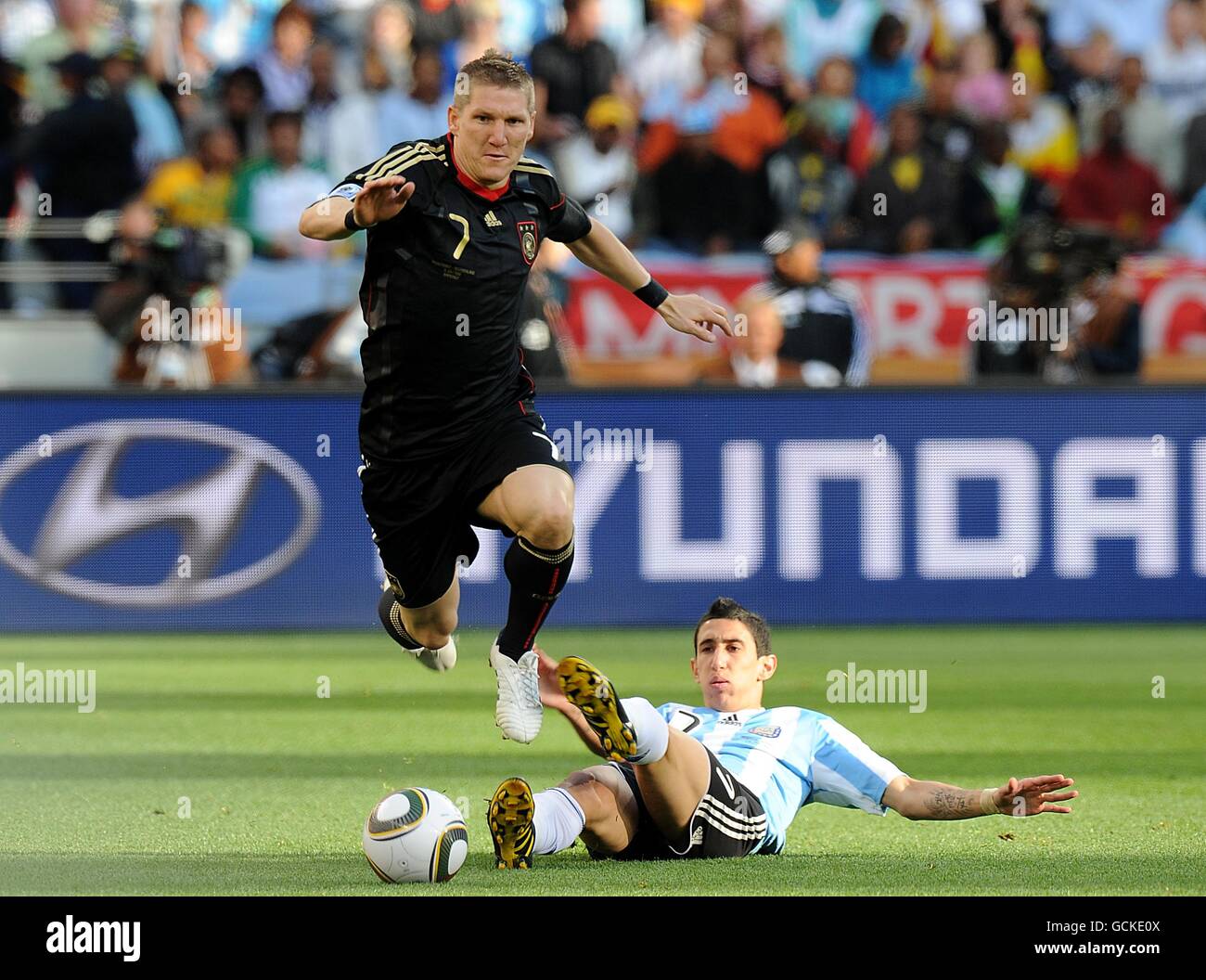 Argentina's Angel Di Maria tries to rckle Germany's Bastian Schweinsteiger Stock Photo