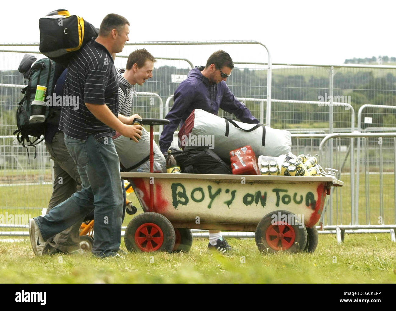 Festival goers use a bath tub on wheels to transport their belongings as music fans begin to arrive for the Oxegen Music festival at Punchestown race course in Co Kildare. Stock Photo