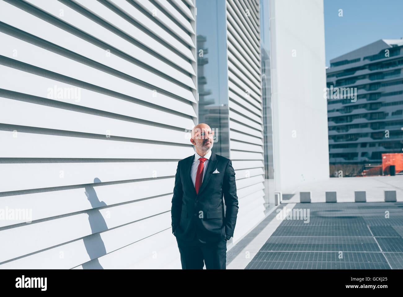 Middle-age contemporary businessman outdoor in the city overlooking pensive - thoughtful, business, thinking future concept Stock Photo