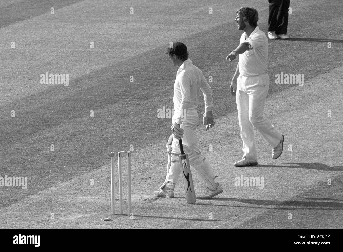 England's Ian Botham points to the fallen bail on the ground as Australia's captain Kim Hughes starts to walk back to the pavilion. Kim Hughes was out to Botham when he hit wicked for 31, after his front foot slid onto the wicket after a hook shot, although at first no-one noticed. Stock Photo