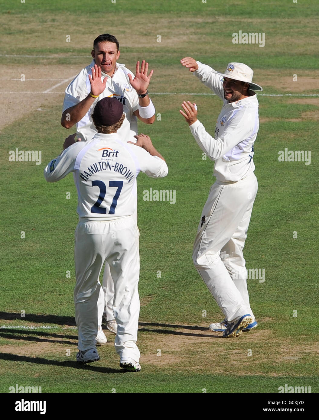 Surrey's Andre Nel (centre) celebrates with Rory-Hamilton Brown (left) and Matthew Spriegel (right) after taking the wicket of Northamptonshire's David Murphy Stock Photo