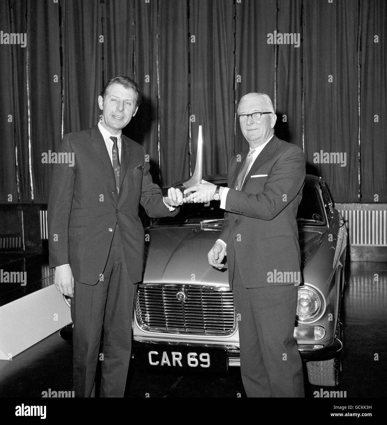 Sir William Lyons (right), chairman of Jaguar, receives 'Car' magazines Car of the Year Award from the Minister of Transport, Richard Marsh for the Jaguar XJ6 Stock Photo