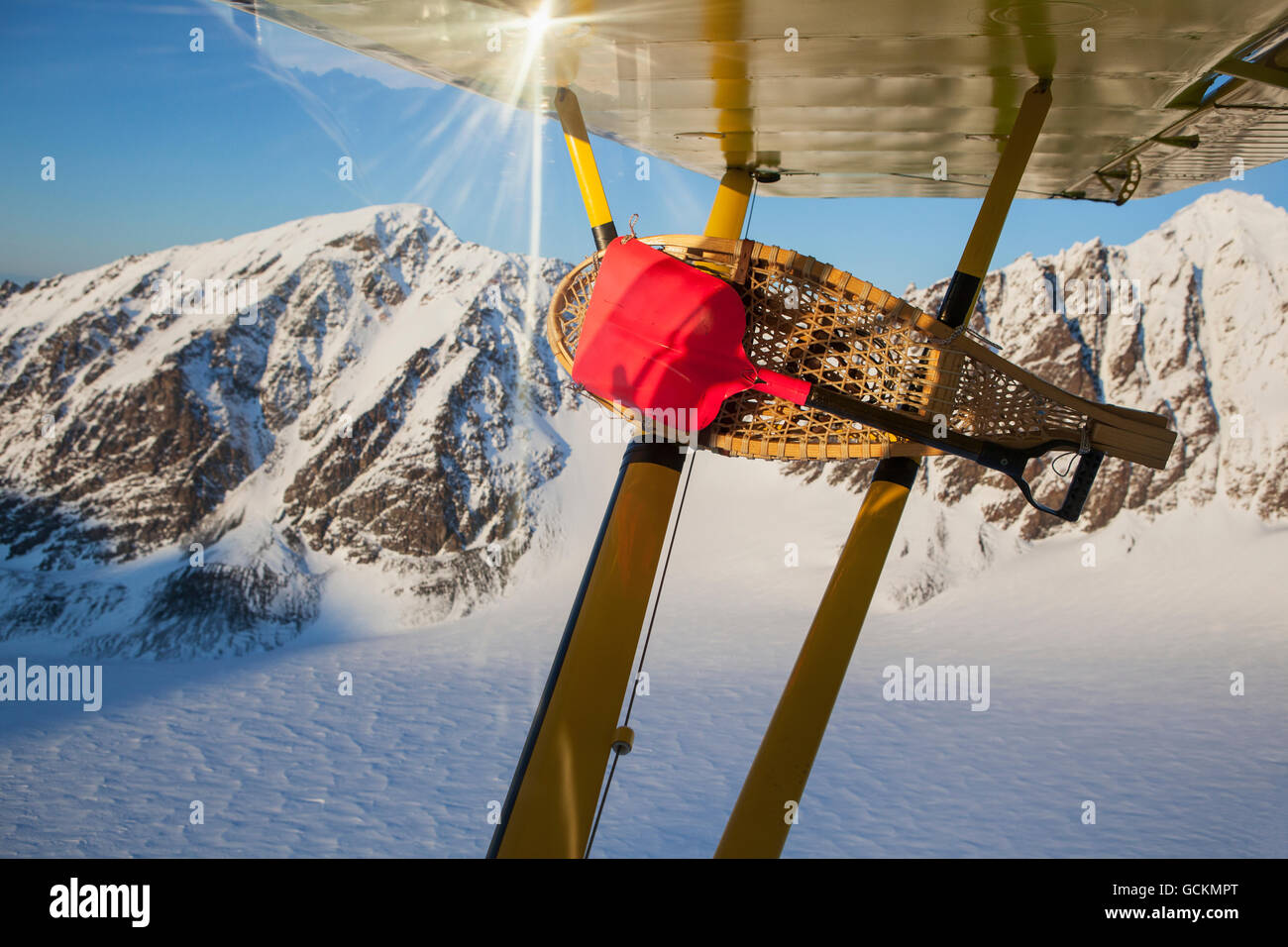 View of traditional snowshoes tied to wing struts of a Piper PA-18 Super Cub while in flight around the Kenai Mountains, Alaska Stock Photo