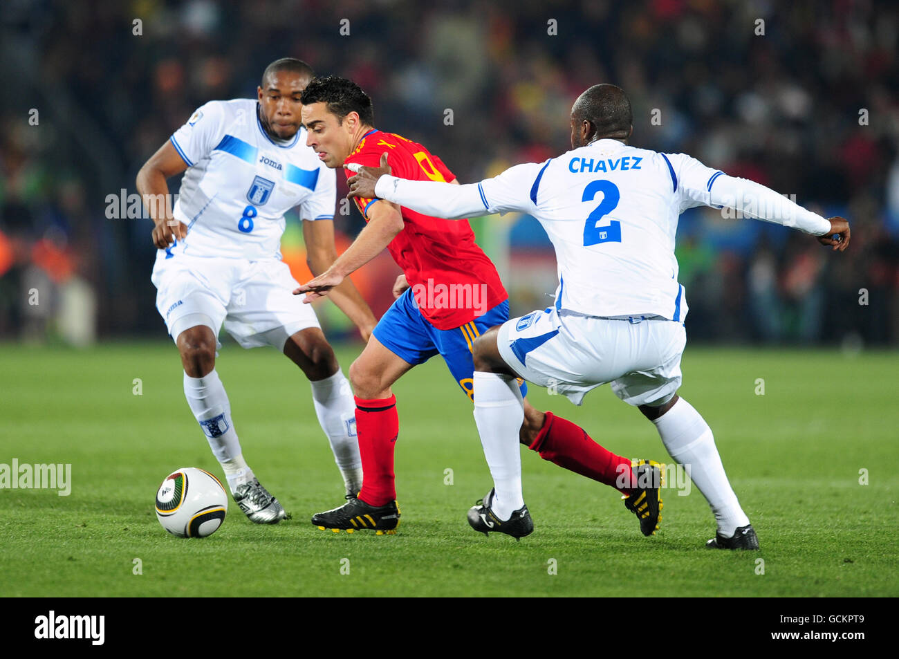 Honduras' Osman Chavez (right) and Wilson Palacios (left) battle for the ball with Spain's Hernandez Xavi (centre) Stock Photo