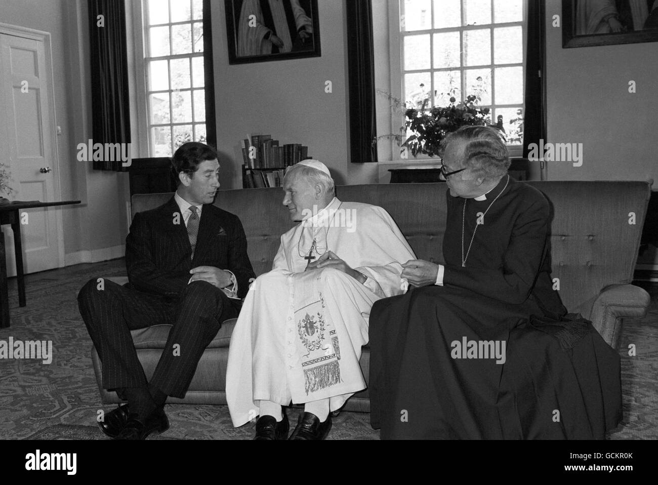 The Archbishop of Canterbury, Dr Robert Runcie, right, with Pope John Paul II, centre, as they had a private meeting with the Prince of Wales in the Library of the Deanery. Stock Photo