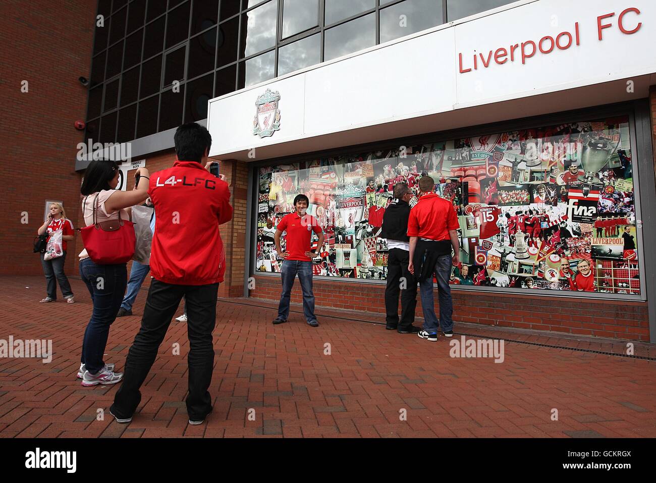 Fans mingle outside of the Liverpool FC Club shop out before kick off Stock Photo