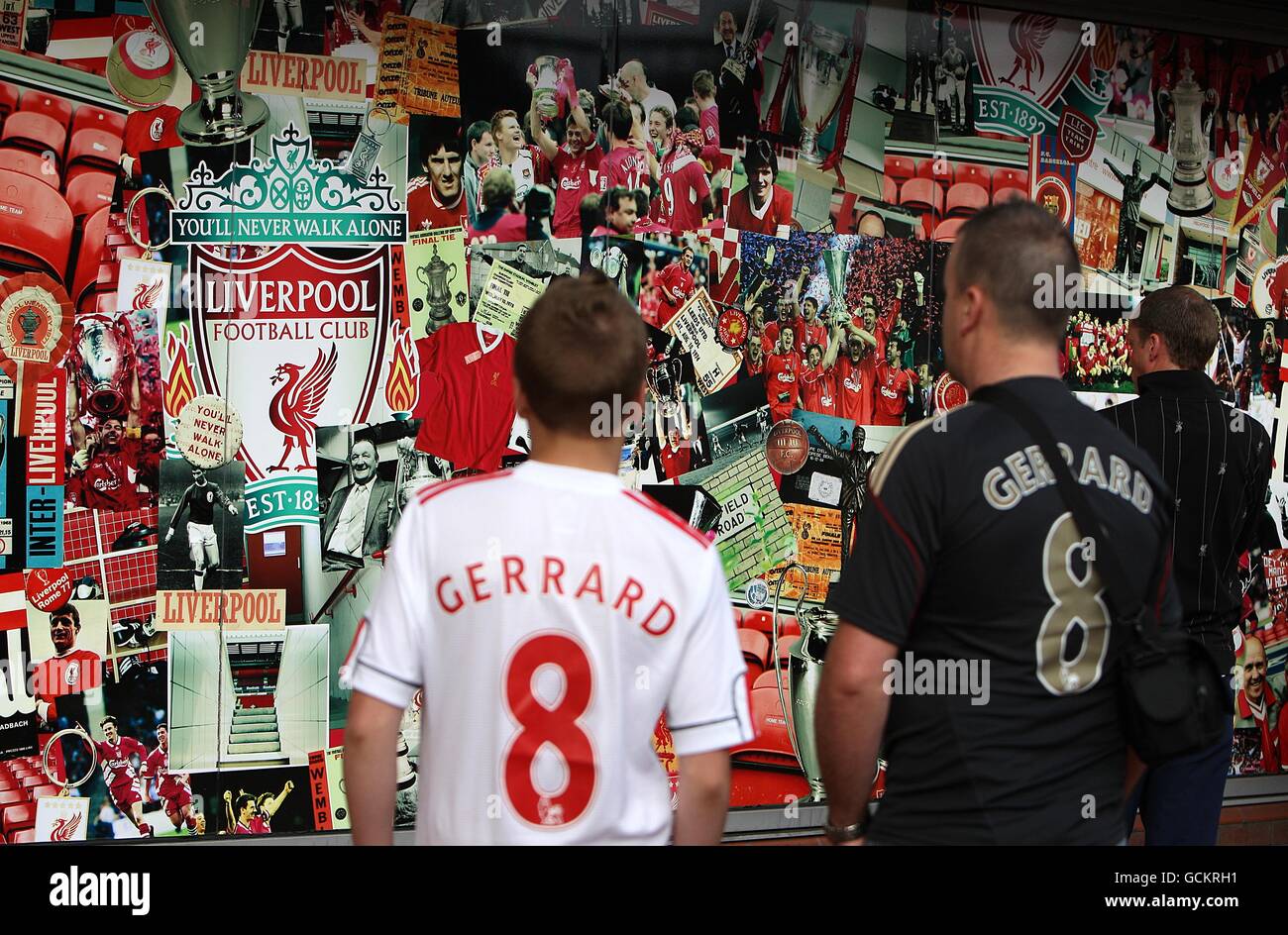 Two fans wearing Steven Gerrard replica shirts gaze at the shop front of the Liverpool FC Club Shop Stock Photo