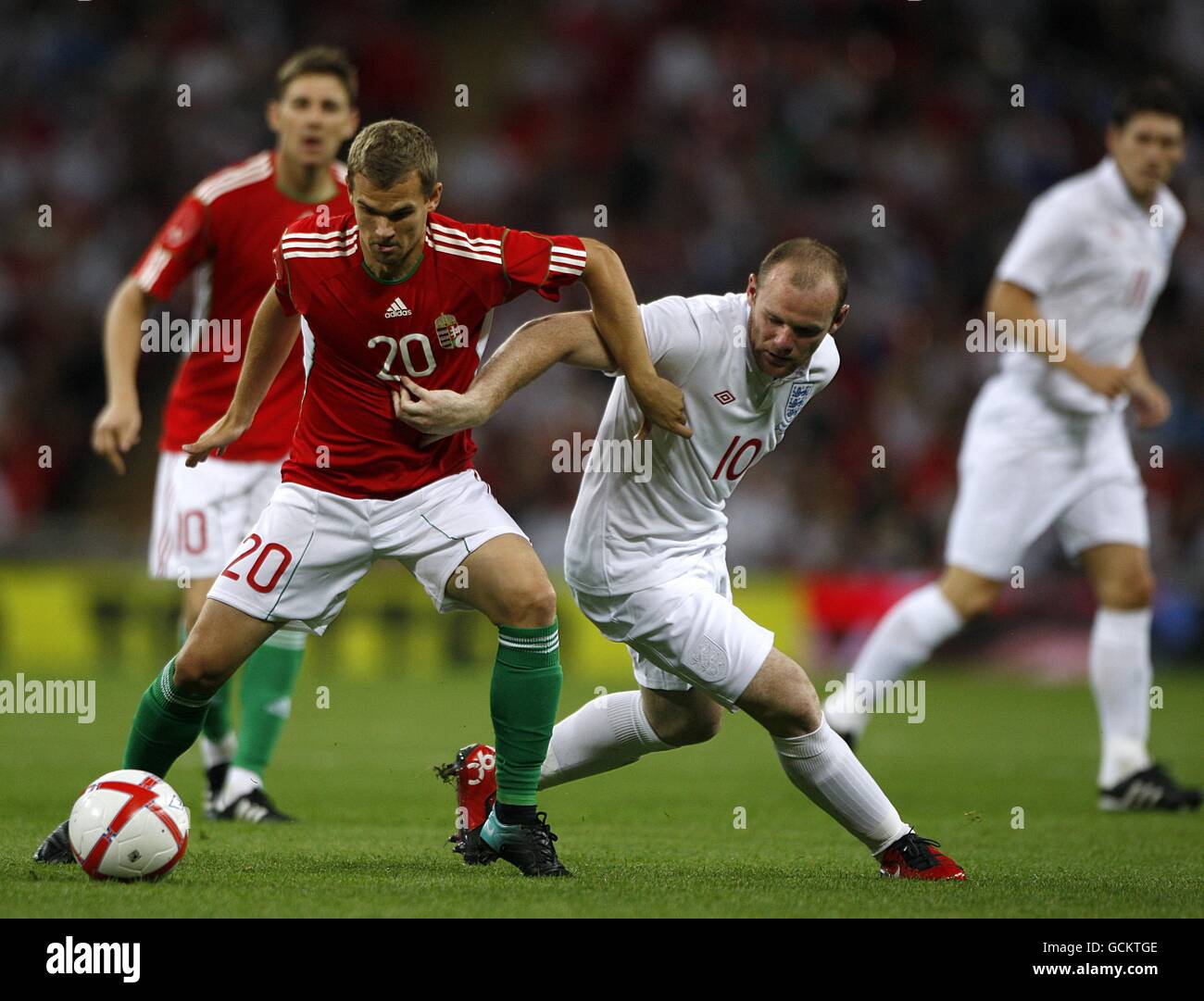 Soccer - International Friendly - England v Hungary - Wembley Stadium. England's Wayne Rooney (right of centre) Hungary's Vladimir Koman (left) battle for the ball Stock Photo