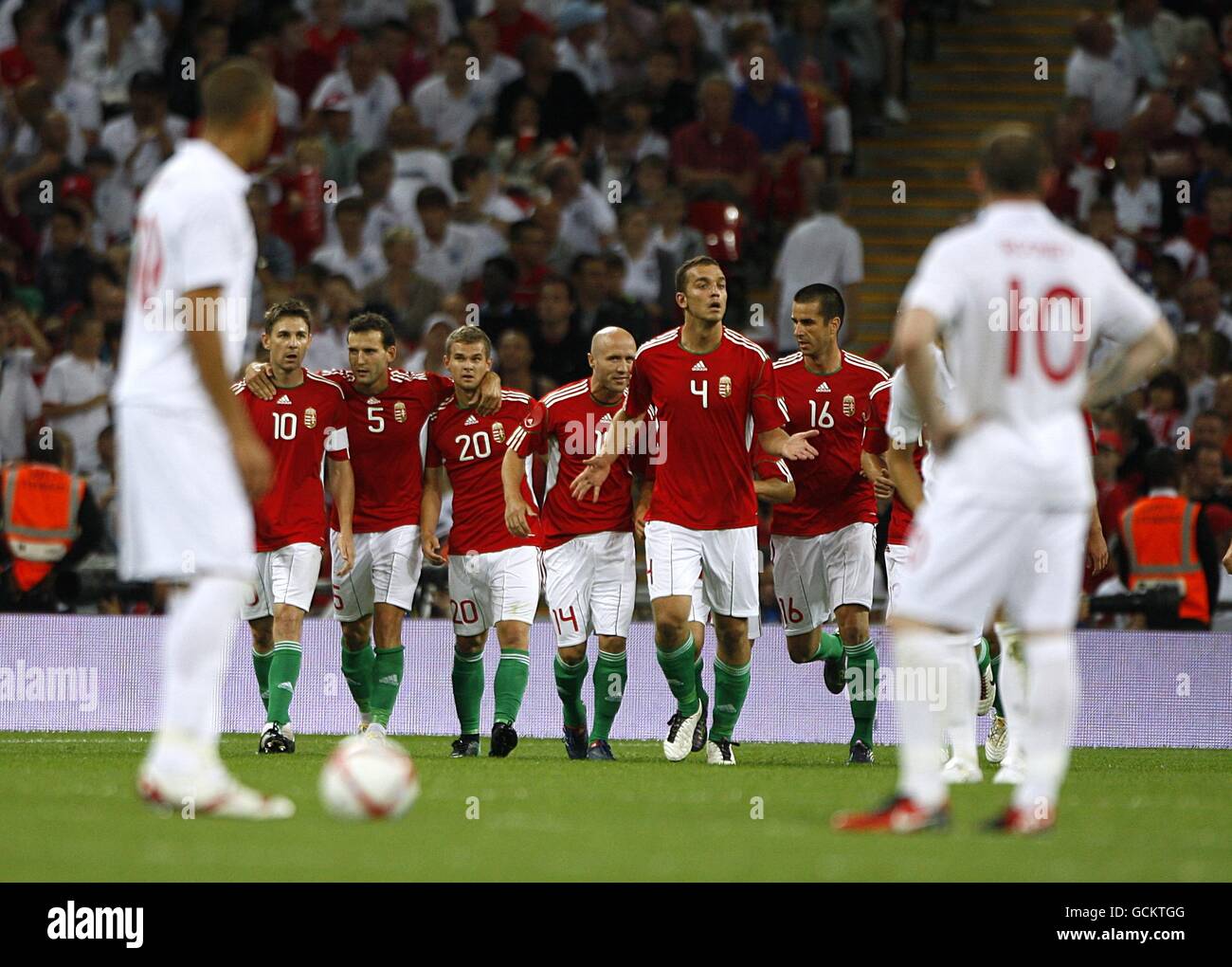 England's Bobby Zamora (left) and Wayne Rooney (right) stand dejected as Hungary celebrate taking the lead Stock Photo