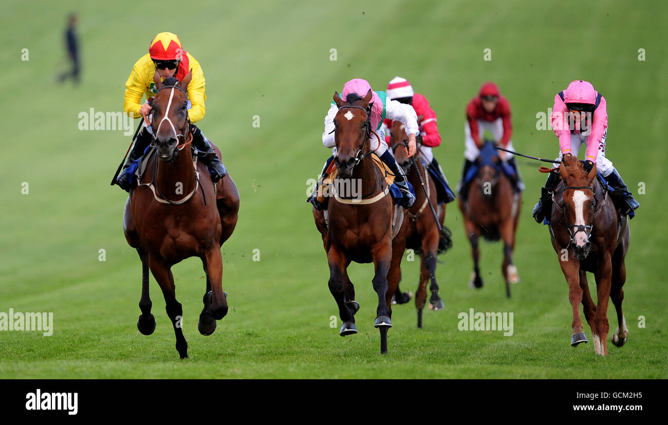 Horse Racing - Epsom Live! featuring JLS - Epsom Downs Racecourse. Eastern Paramour (left) ridden by Steve Drowne wins The Brothers Pear Cider Maiden Fillies Stakes ahead of Mascarene, Ryan Moore on 2nd. Stock Photo