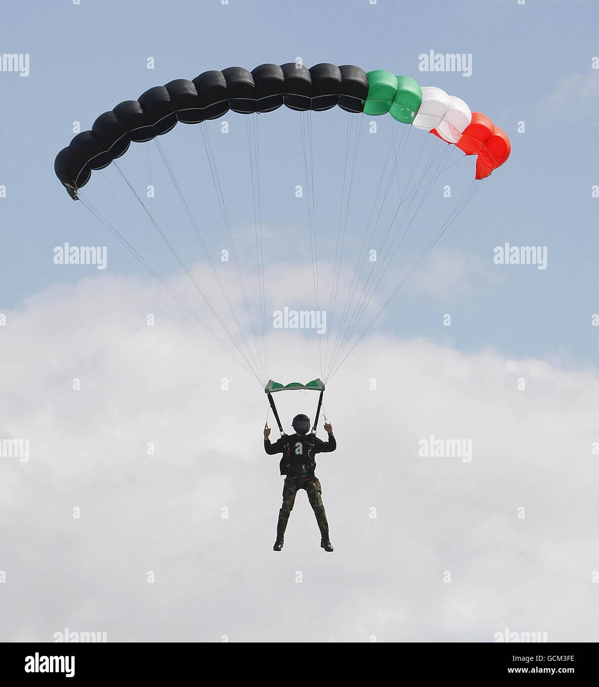 A member of the Irish Army Parachute Team the black knights takes part in a display during the commemoration of the 50th anniversary of the first deployment of Irish peacekeepers to the Congo at Casement Aerodrome, Baldonnel. Stock Photo