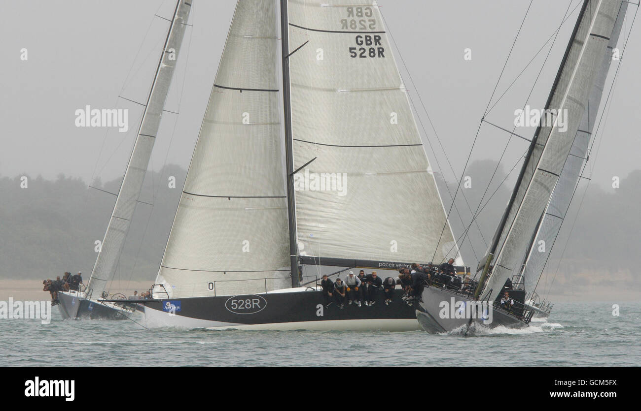 Sir Peter Ogden steers his new yacht Jethou (right) past Pace and Bob, (left) part owned by BP CEO Tony Hayward as they tack during racing in the class 0 fleet on the first day of Cowes Week, Isle of Wight. Stock Photo