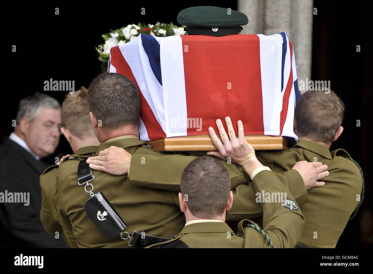 Pallbearers from the Rifles shoulder the Union Flag draped coffin of Major Josh Bowman as he is led into Salisbury Cathedral where a funeral service is being held in his honour. Stock Photo