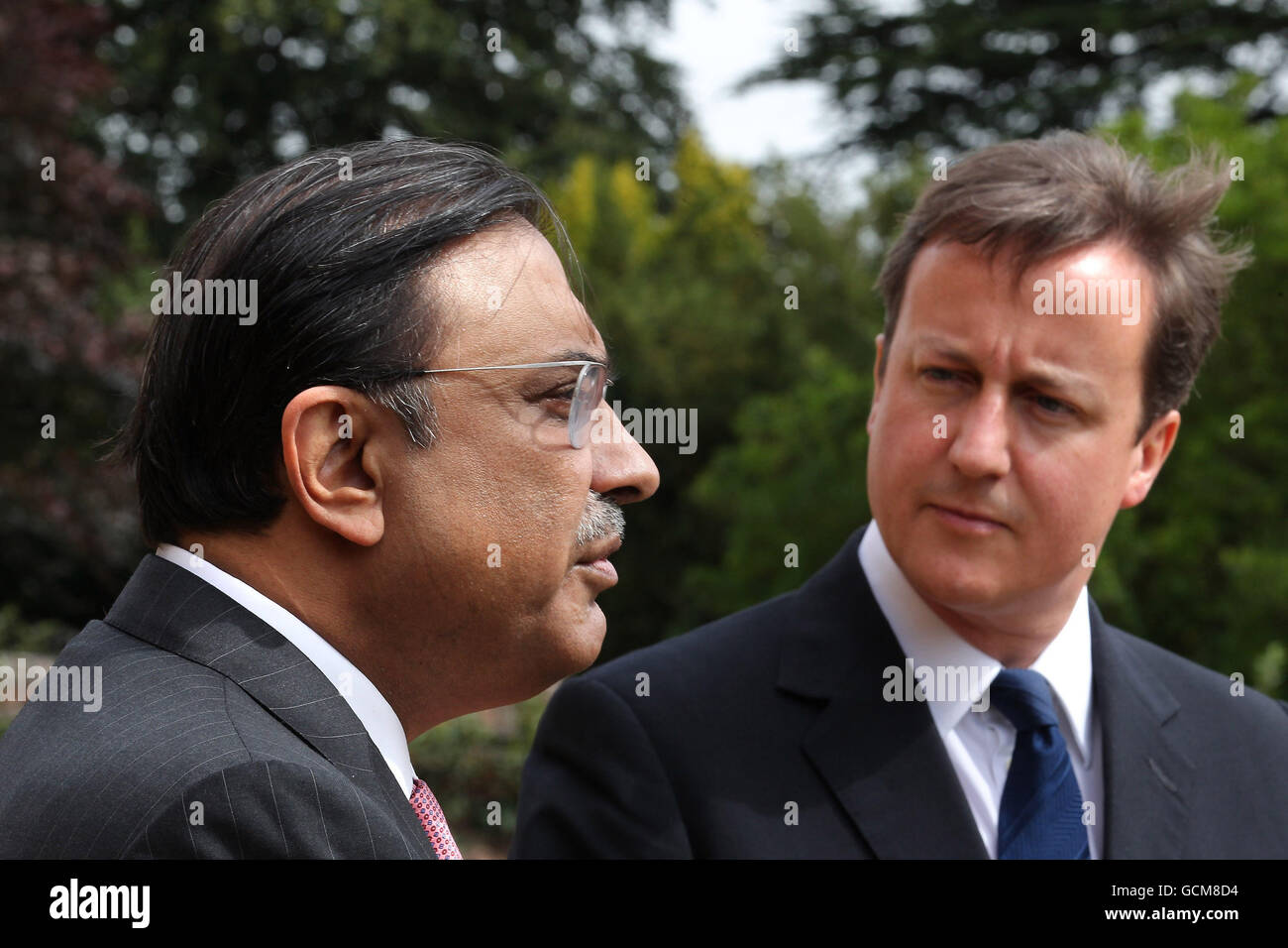 Prime Minister David Cameron (right) looks at Pakistan's President Asif Ali Zardari as they speak to reporters at Chequers near Princes Risborough, England. Stock Photo