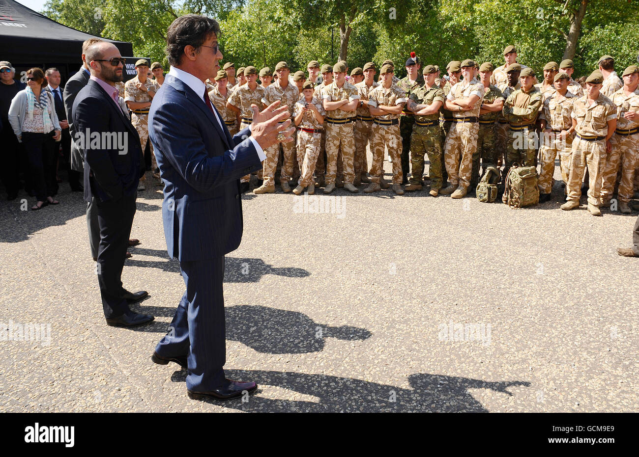 Sylvester Stallone (front), Jason Statham (centre) and Dolph Lundgren meet troops from the Princess of Wales Royal Regiment, at the Wellington Barracks in London before tonight's premiere of The Expendables. Stock Photo