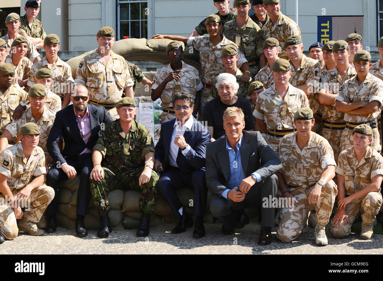 Jason Statham, Sylvester Stallone and Dolph Lundgren meet troops from the Princess of Wales Royal Regiment, at the Wellington Barracks in London before tonight's premiere of The Expendables. Stock Photo