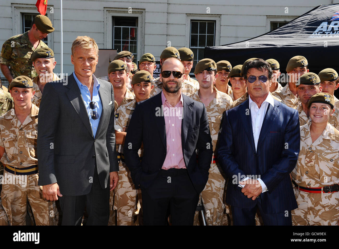 Dolph Lundgren (left), Jason Statham (centre) and Sylvester Stallone meet troops from the Princess of Wales Royal Regiment, at the Wellington Barracks in London before tonight's premiere of The Expendables. Stock Photo