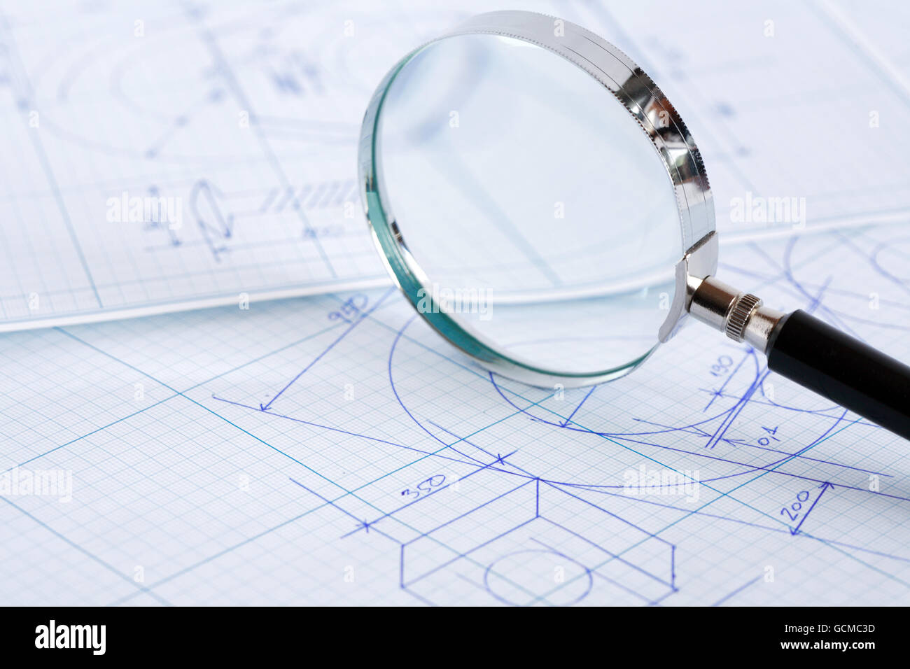 Closeup of magnifying glass on blueprint with draft Stock Photo Alamy