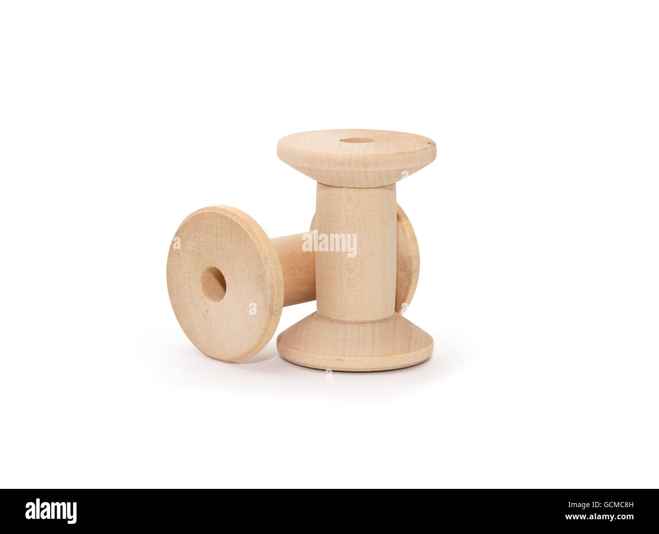 Two empty wooden sewing spools on white background. Isolated with clipping path Stock Photo