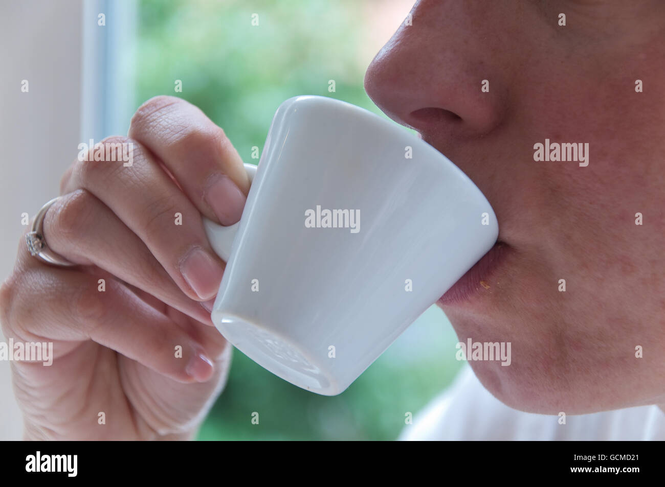 https://c8.alamy.com/comp/GCMD21/beautiful-girl-drinking-coffee-during-breakfast-GCMD21.jpg