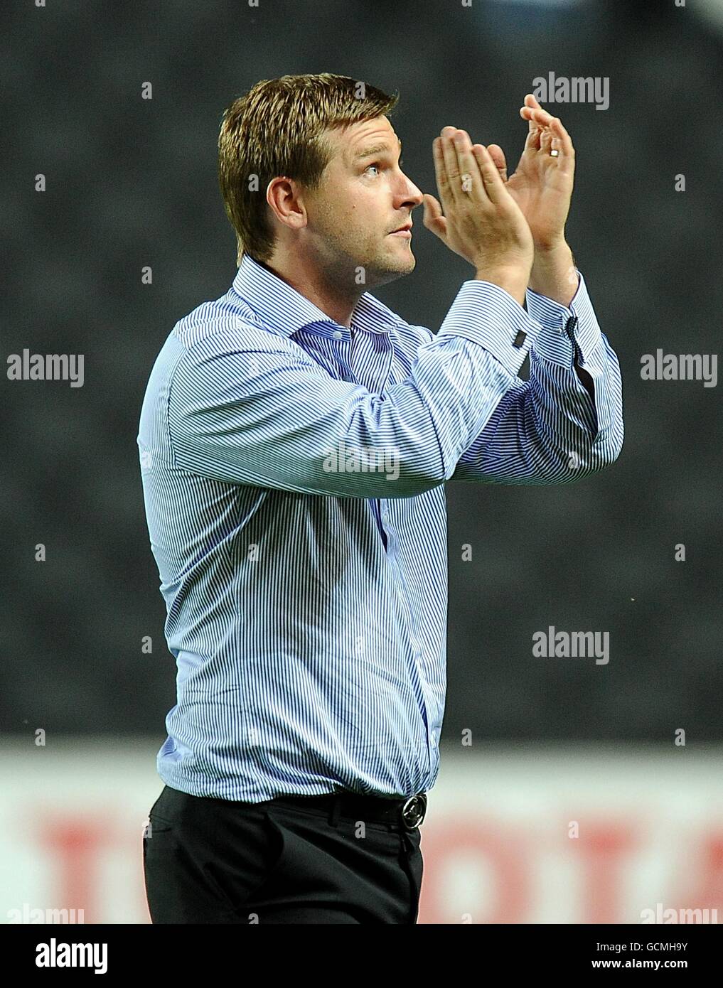 Milton Keynes Dons manager Karl Robinson applauds the fans after the final whistle Stock Photo