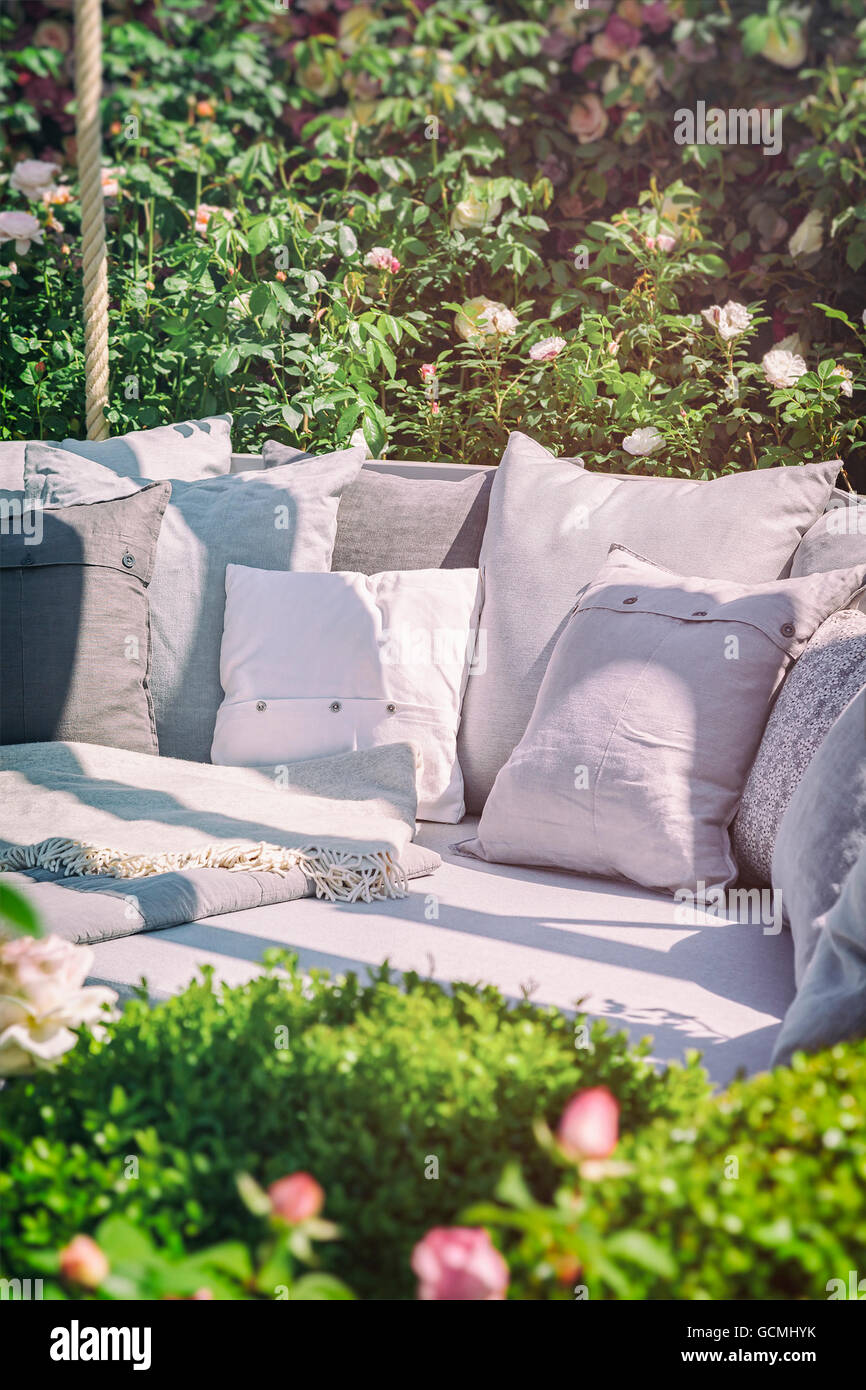 Image Of Cozy Garden Seating Area With Cushions Stock Photo