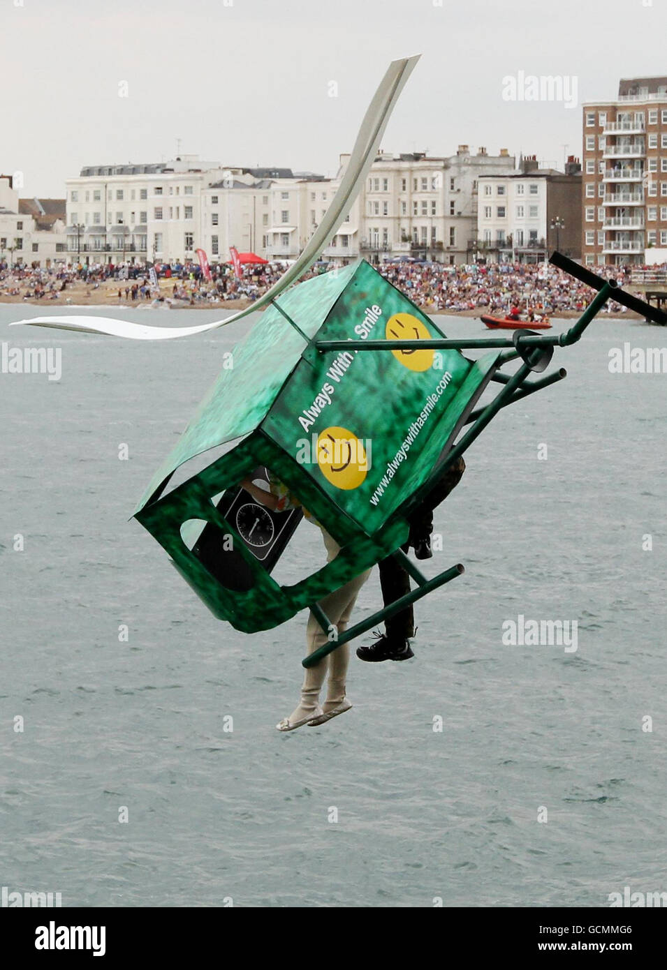 The Rainbows Children Hospice competitors including BBC Presenter Holly Walsh leap off the pier at the Worthing International Birdman competition in Worthing, West Sussex. Stock Photo