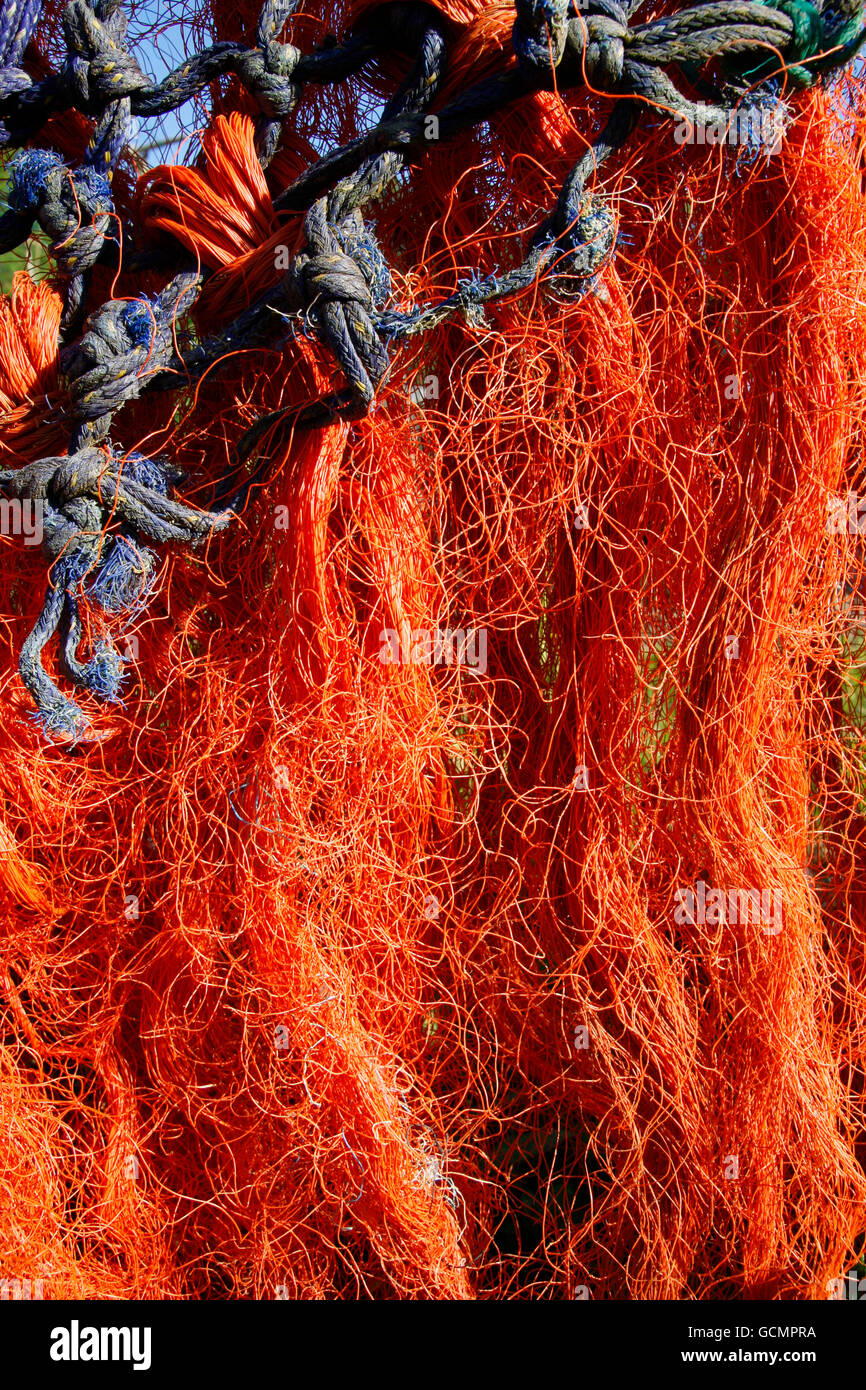 Orange fishing net hanging out to dry Stock Photo Alamy