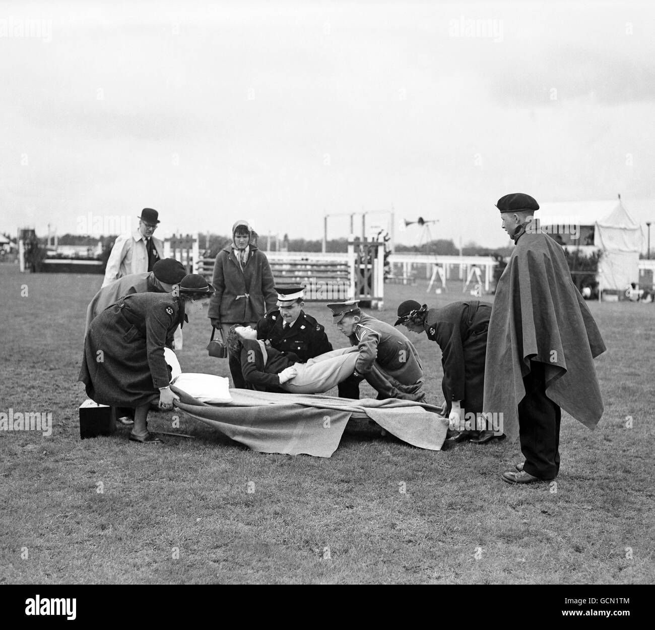 Horse Racing - Ascot Jumping Show - Ascot. Miss D.Butler who was hurt when 'Hibernian'(187) rolled on her after a fall in the Wild Boar Championship, is assisted after the accident. Stock Photo