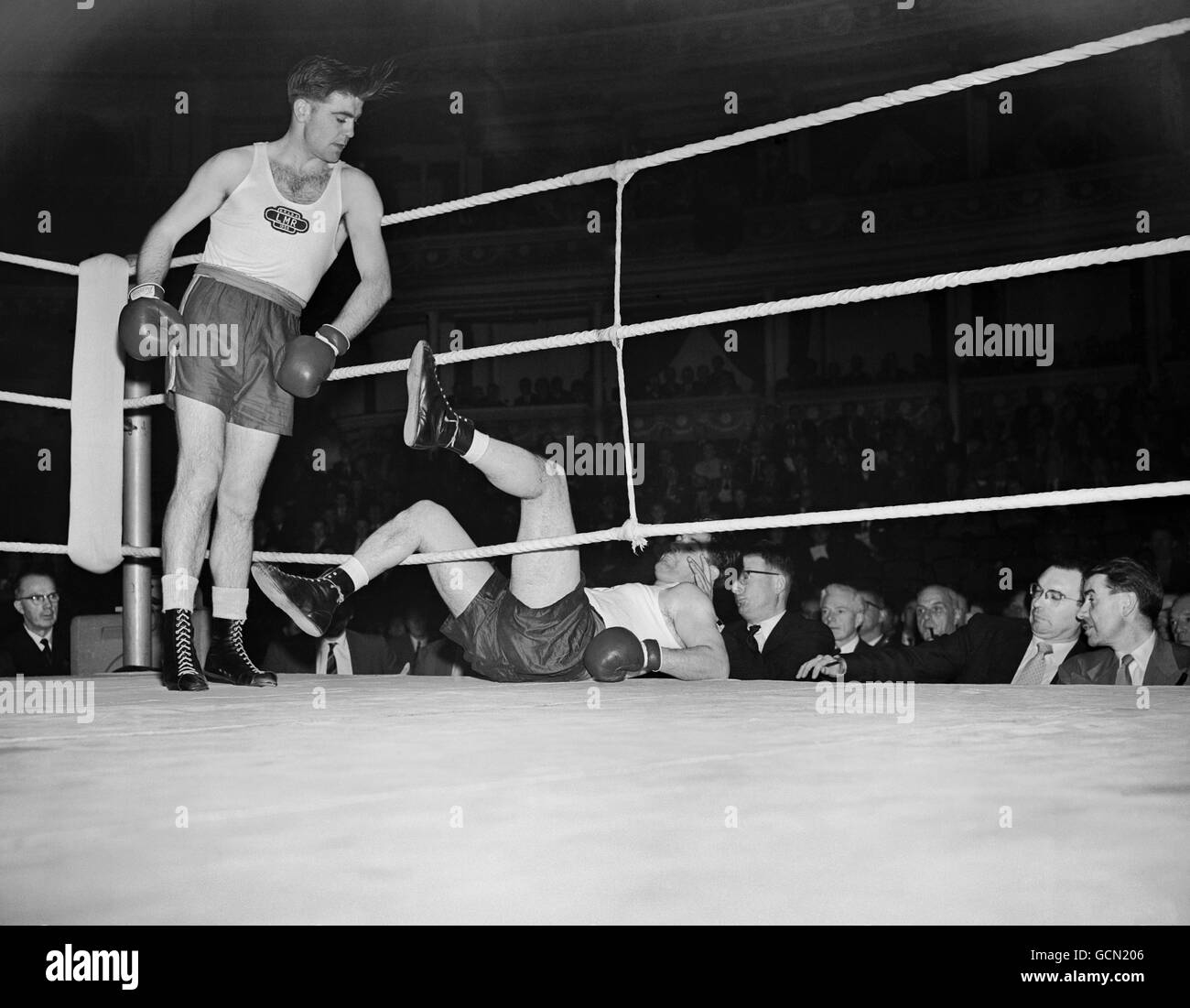 Boxing - British Railways Amateur Boxing Championships - London. Light heavyweight J.Cunningham, the winner, knocks J.Gill through the ropes. The Royal Abert Hall, London. Stock Photo