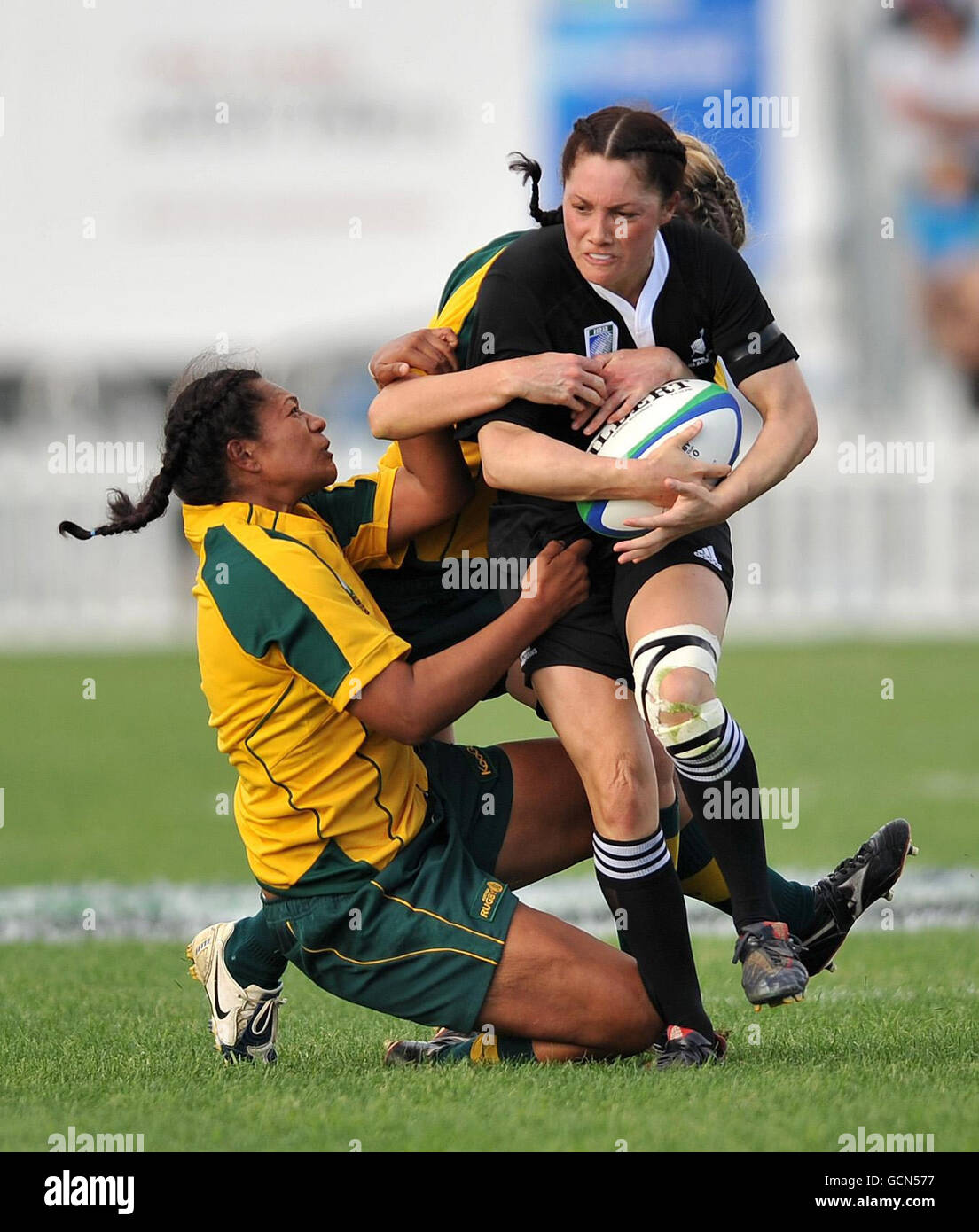 New Zealand's Victoria Grant is tackled by Australia's Se'el Sa'U (left) and Tobie McGann during the IRB Women's World Cup match at Surrey Sports Park, Guildford. Stock Photo