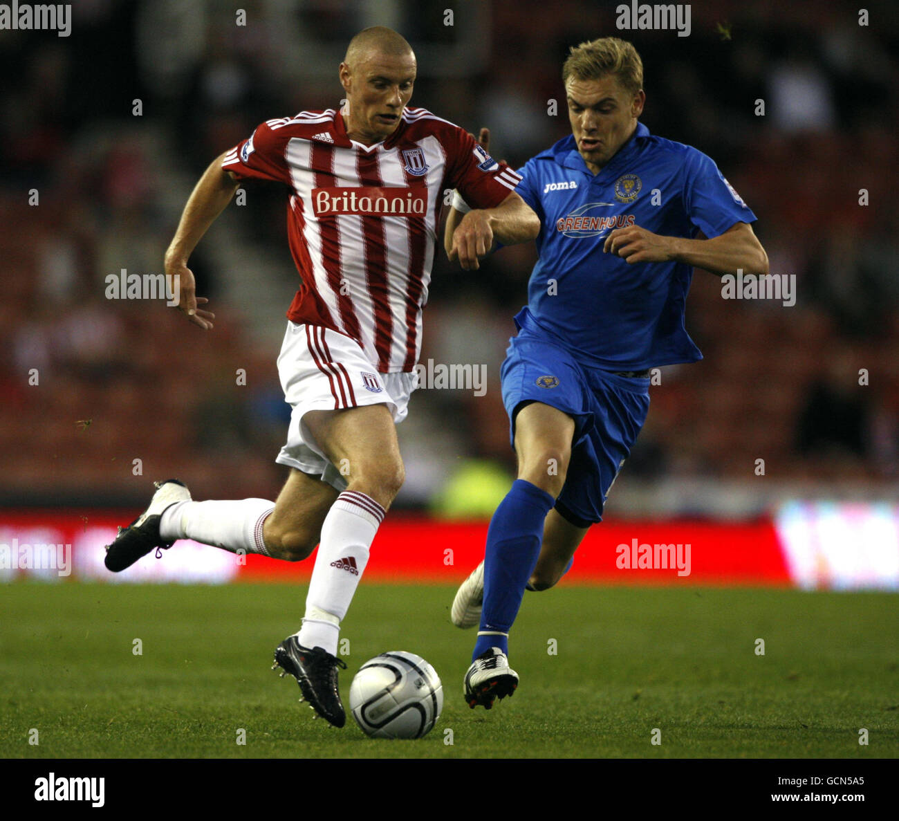 Stoke City's Ryan Shawcross (left) holds off a challenge from Shrewsbury Town's Benjamin Van Den Broek during the Carling Cup, Second Round match at the Britannia Stadium, Stoke. Stock Photo