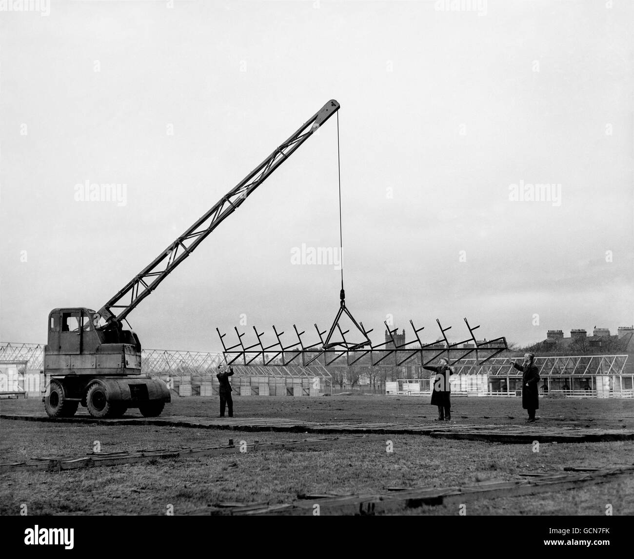 One of the big mobile cranes on the site lifting a grandstand cross beam. Stock Photo