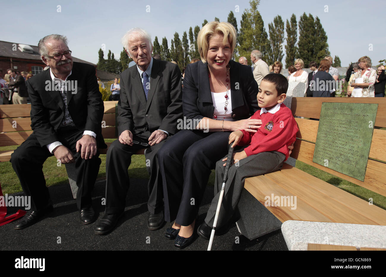 (left to right) Robert Ballagh, Nobel Laureate Seamus Heaney, Education Minister Mary Coughlan and six-year-old Laurentiu Kovaci sit on a bench that was unveiled during a special ceremony at St Joseph's Centre for the Visually Impaired in Dublin. Stock Photo