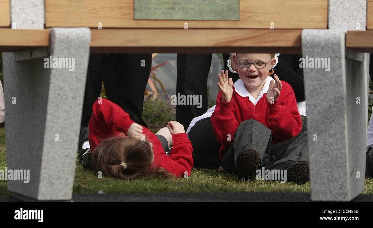 5-year-old Sam Freeney (right) sits under a bench designed by artisit Robert Ballagh that was unveiled during a special ceremony at St Joseph's Centre for the Visually Impaired in Dublin. Stock Photo
