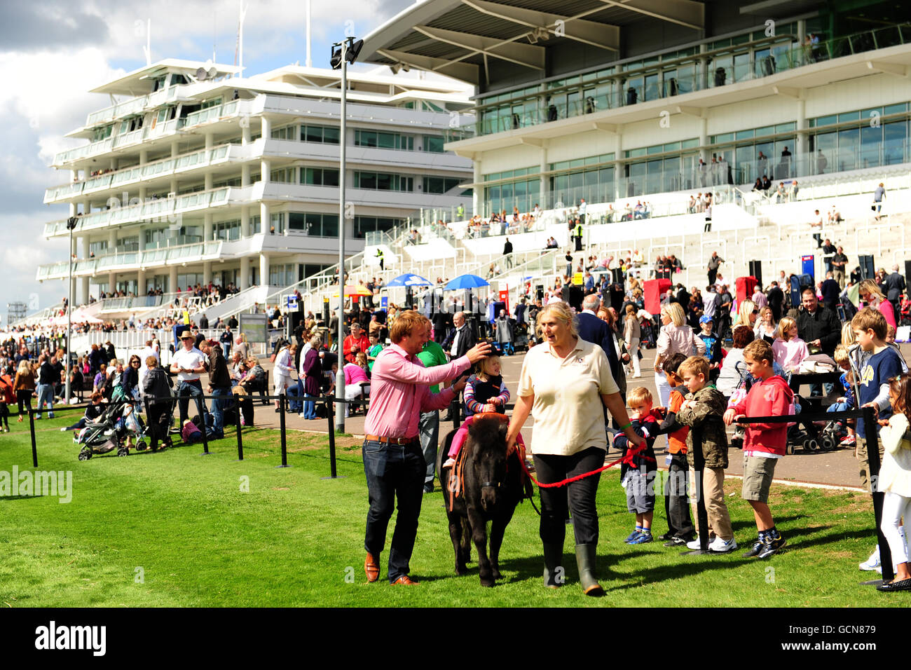 Children enjoy pony rides during the family funday hires stock