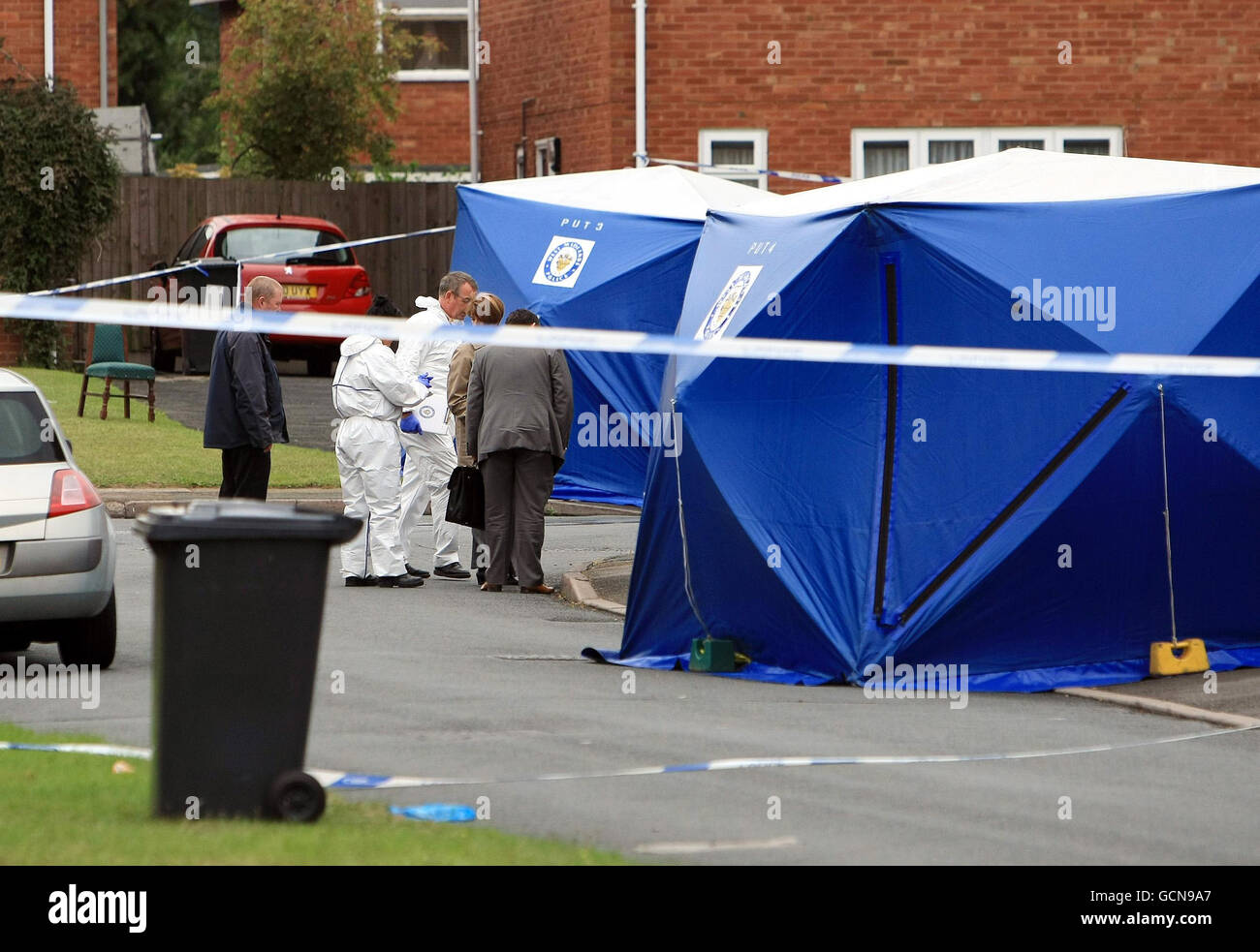 Police officers examine the scene of a murder after a man was stabbed to death. West Midlands Police said two other men also suffered stab wounds during the incident in Crosby Close, Whitmore Reans, Wolverhampton at about 10.45pm yesterday. Stock Photo