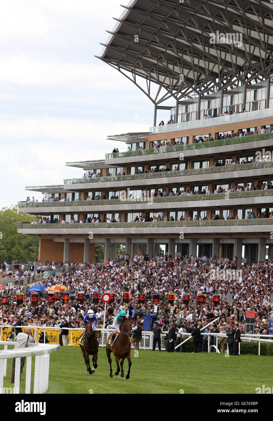 Horse Racing - Betfair Weekend King George Day - Ascot Racecourse. A general view of racing in front of the grandstand Stock Photo