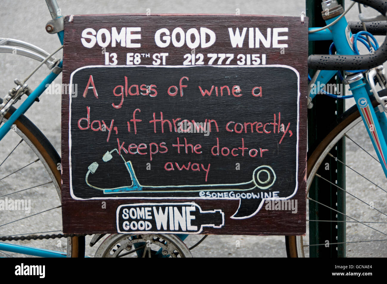 A Funny Sign Advertising For A Liquor Store In Greenwich Village Ny Satirizing An Apple A Day Keeps The Doctor Away Stock Photo Alamy